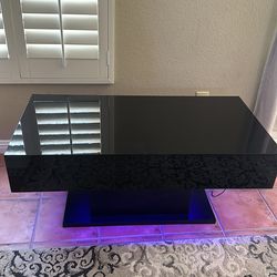 Glossy black coffee table with LED light