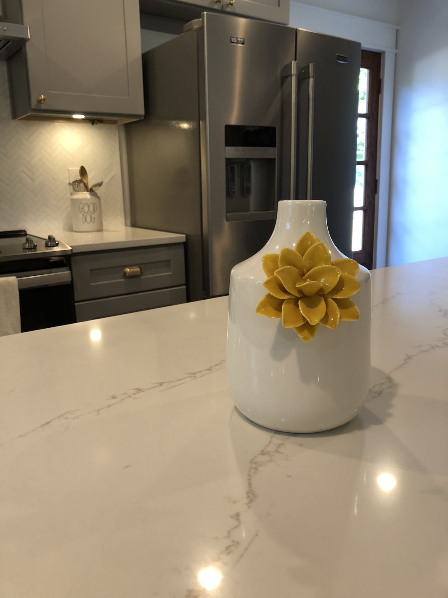 White ceramic vase with yellow flower