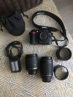 Nikon camera + two lenses + accessories + Nikon thermos/cup