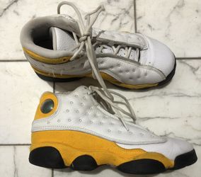 Air Jordan 13 Retro "Del Sol" sneaker in a white and university yellow colorway. 