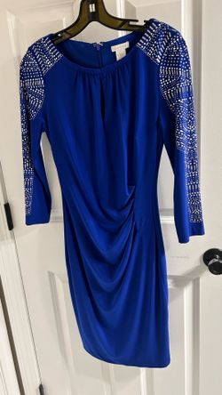 Elegant Calvin Klein dress is blush pink. Has a boat neck and cap sleeves. Features a pleated waist detail and a gold zipper closure on the back. This
