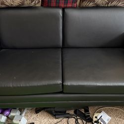 Black loveseat/two-seater sofa. 