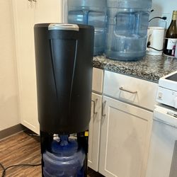 Water Dispensary With 4  Of The 5 Gallons 