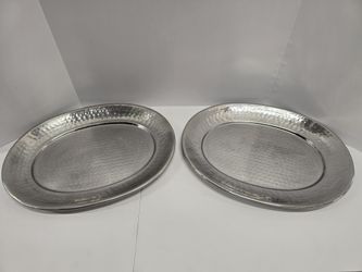 set of two hammered silver-tone oval serving trays. The hammered finish adds texture and shine