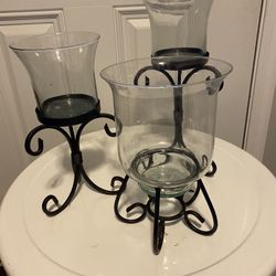 Set of three matching decorative candle holders with metal base