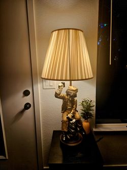A lamp with a boy figure