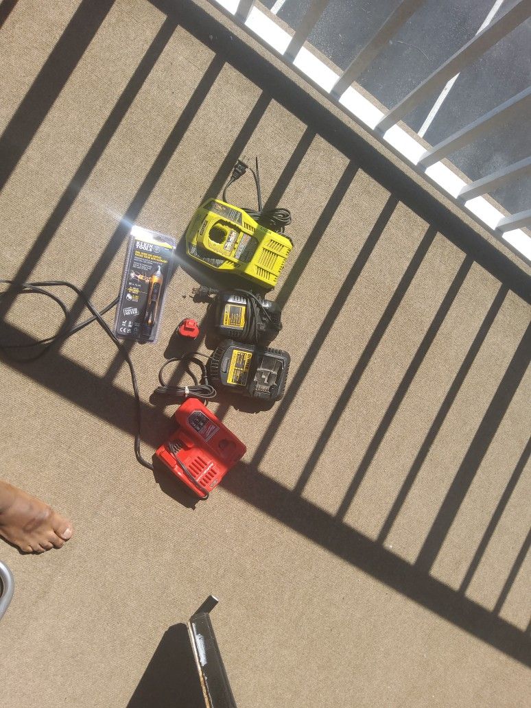 Drill Battery Chargers And One Milwakee Battery And A Voltage Detector
