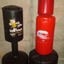 Two Heavy Duty Punching/Kicking Bags With Stand And An Extra Heavy Bag