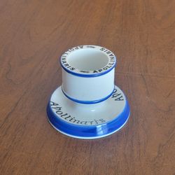 Apollinaris Ceramic Match Striker Holder, Antique Pub Advertising. 
Dating back to beginning of 20th century.
Ribbed cylindrical body for striking mat