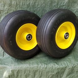 Pair of 13x6.50-6 Reliance Flat Free ribbed lawnmower tires on JD yellow wheels for zero turn mowers