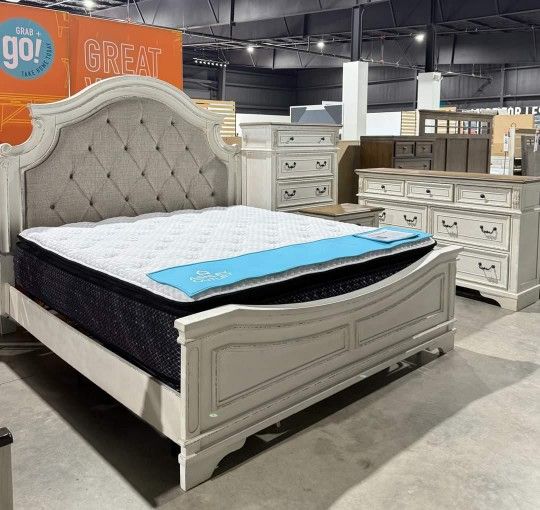 Realyn Chipped White Upholstered Panel Bedroom Set. Bed, Dresser, Mirror, Nightstand, Chest
