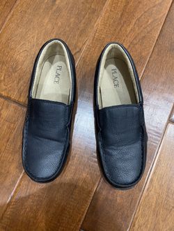 Children place boys dress shoes