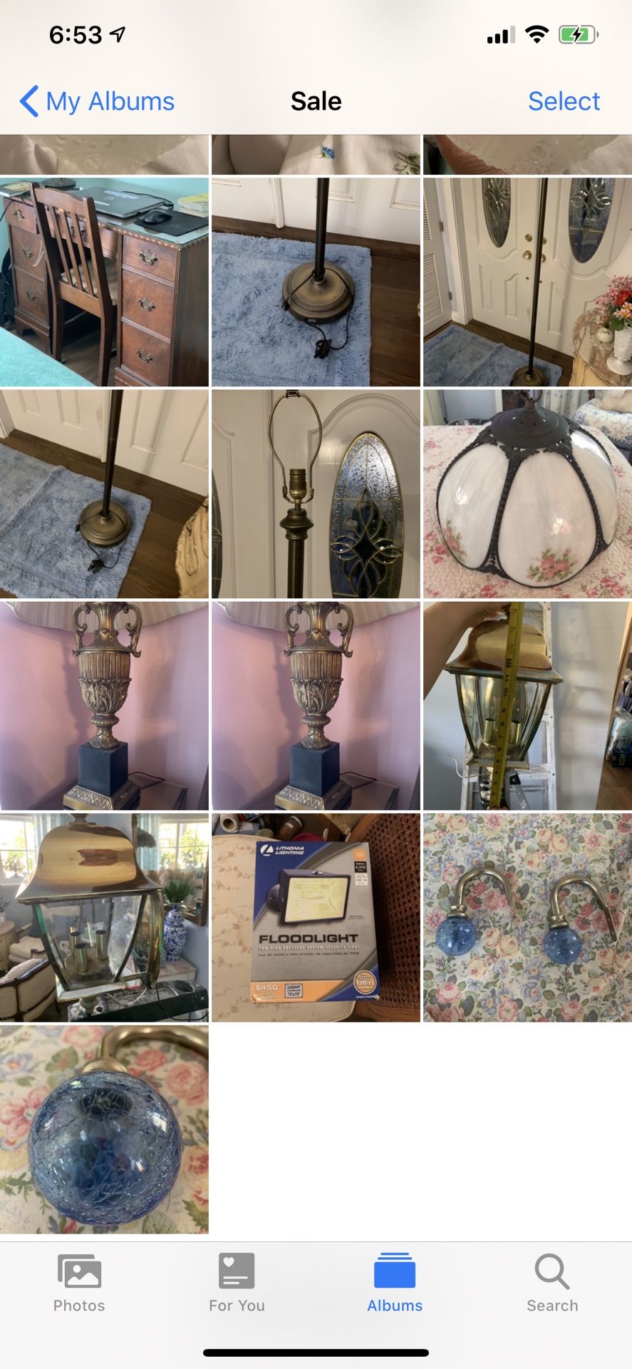 Tons of antiques vintage furniture lights flood base of Tiffany lamp brass outdoor light curtain ties