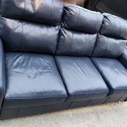 Blue Leather Couch (Tip Top Shape) Price To Sell Fast...The couch has Been Moved Into storage.