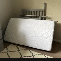 Crib mattress almost new with protection sheet on it 