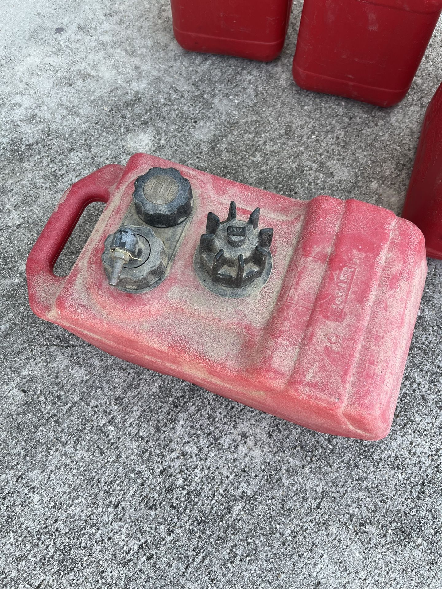 Small boat, fuel tank and miscellaneous gas cans