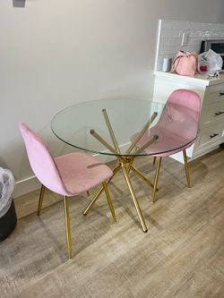 Round Glass Dining Table with 2 Pink Chairs