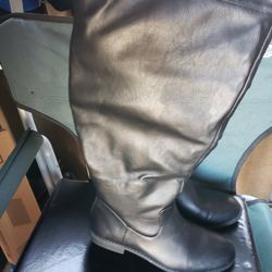 Black Pair Boots With Zipper In The Back And A A New Pair Of Brown Suede Boots Black Bottom