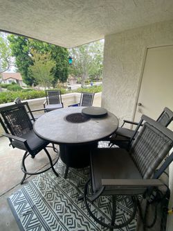 Outdoor table set with fire pit