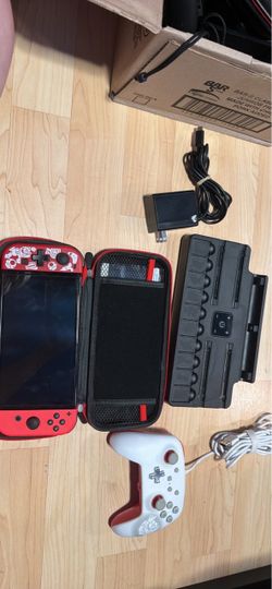 Nintendo switch OLED with docking station, charger, and extra controller