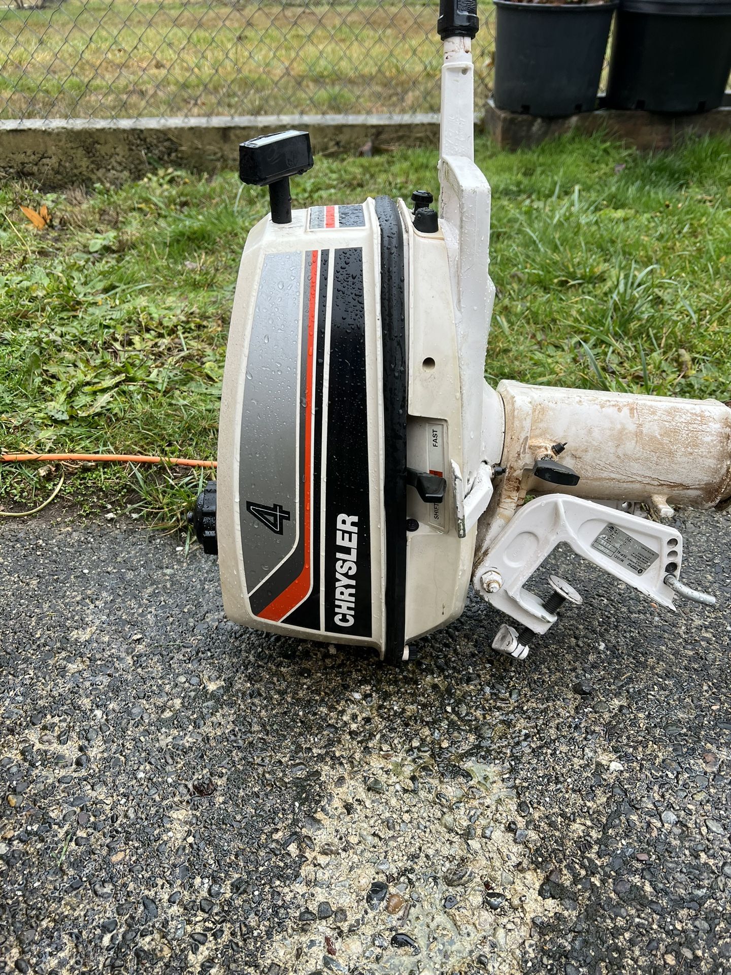 White chrysler 4 hp outboard motor it is two stroke runs great live