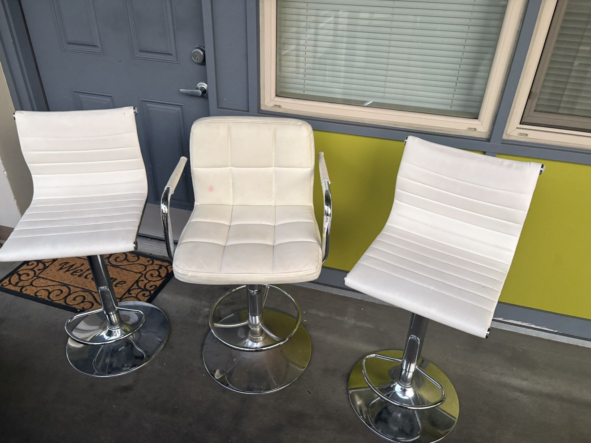 three bar stools. some stains, a little rust.