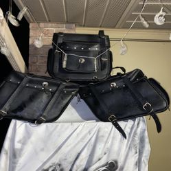 black leather American Rider motorcycle luggage, specifically a sissy bar travel bag (center/top) and a pair of saddlebags (left and righ
