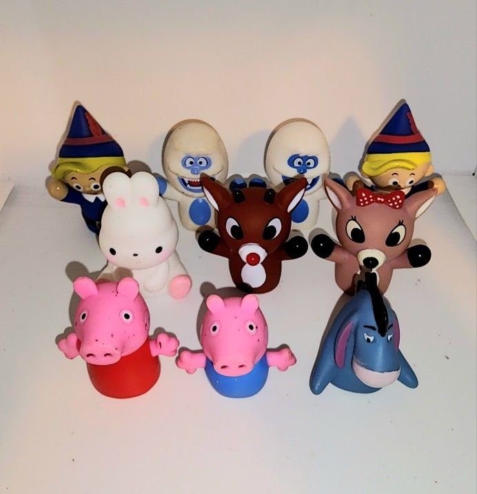 finger puppets from Rudolph the red nose reindeer, Peppa Pig, and eeyore 