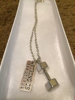 Men's fitness barbell with tag that says strong is beautiful necklace
