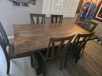 Brown dining room table with 6 chairs