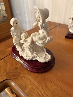 Guiseppe Armani boy and girl on a see saw