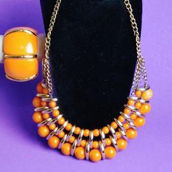 This vintage Old Orange Bead Choker Necklace with Bracelet is a unique and stylish piece of jewelry for women. The necklace features a choker style wi