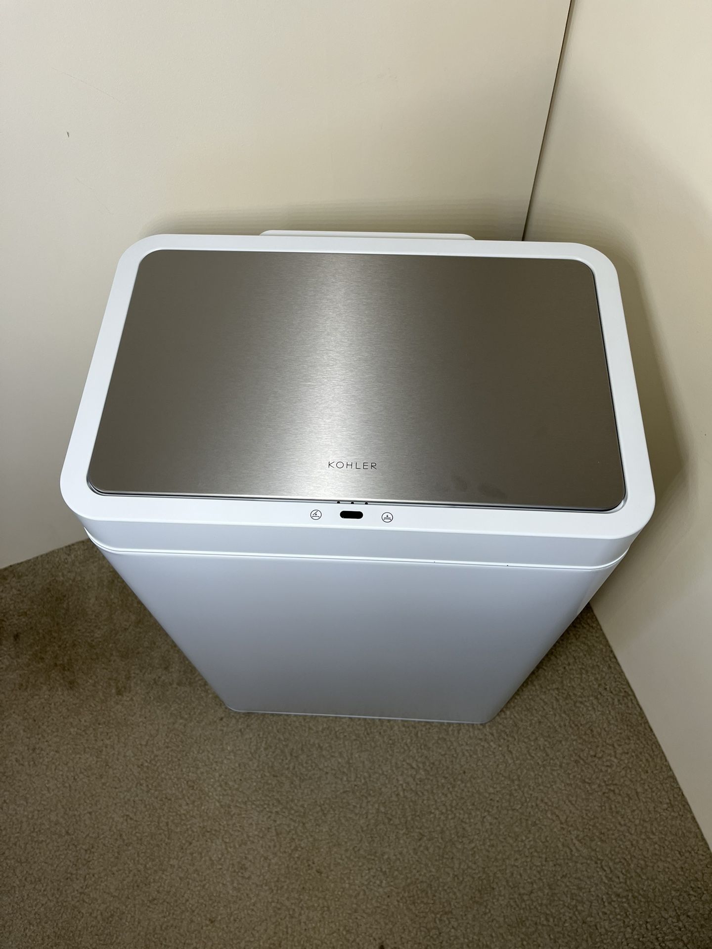 New Kohler 48L Motion, white Sensor Trash Can with a tiny dent on the left and right. See pictures.