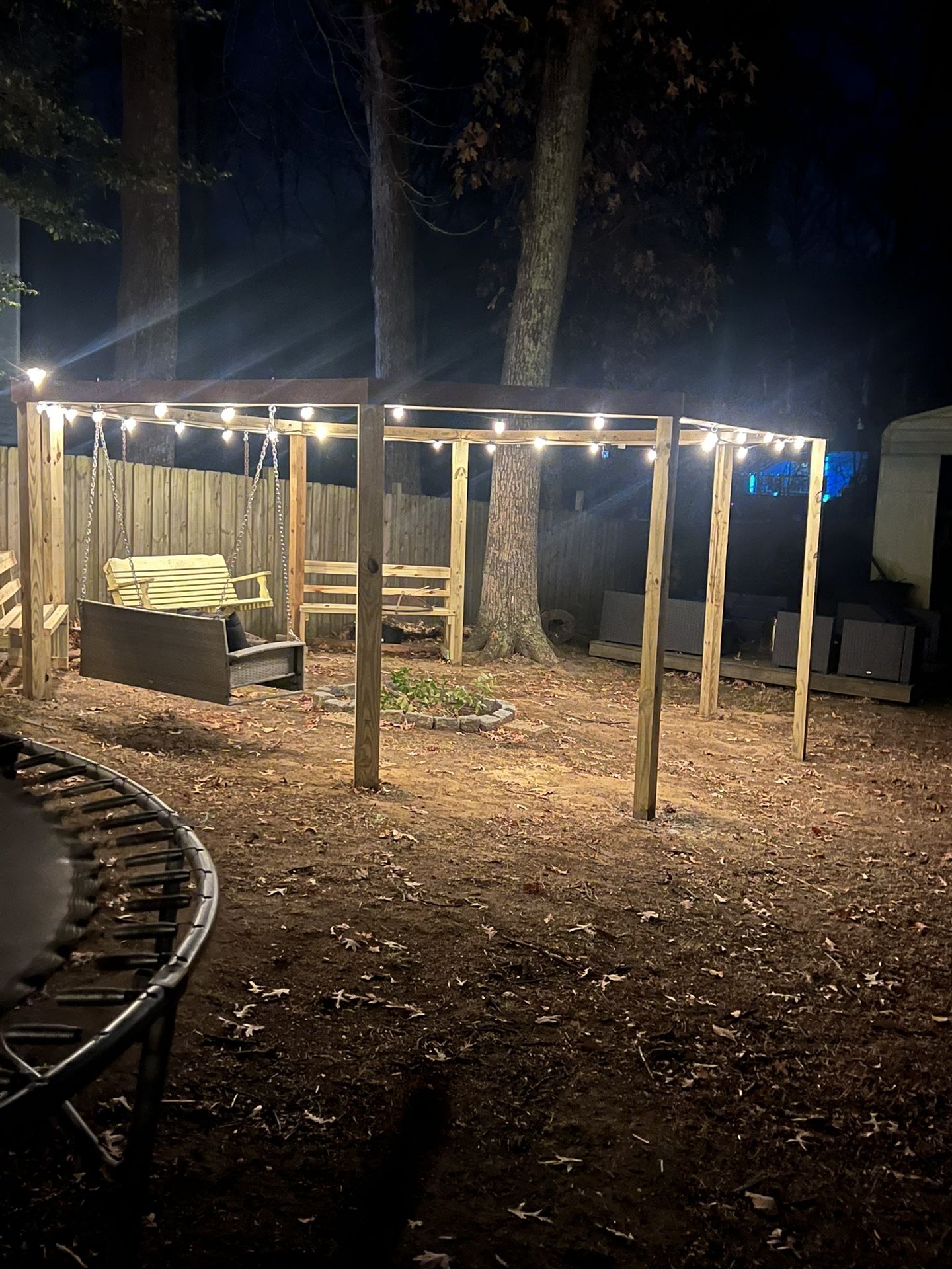 Open gazebo swing set with fire pit