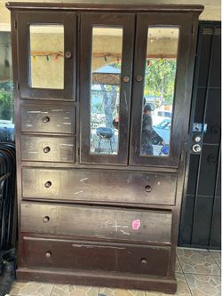 Large wooden piece of furniture with 5 drawers and 3 mirrors.
