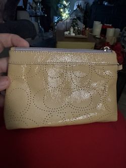 Coach patent leather perforated signature C wristlet. 