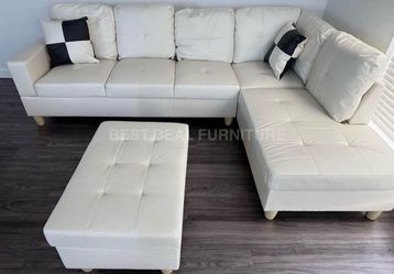 White leather sectional couch and ottoman