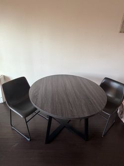 Ashley table with 2 chairs ,first person that brings $75 firm for everything take it Costa Mesa.