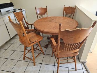 Wooden dining table and chairs (five wooden chairs, one of which is a high chair that can rotate)