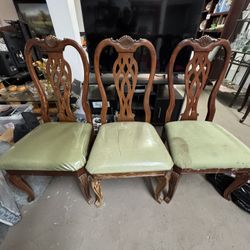 3 Chairs Wood And Cushion One Has Stains Other Two Covered With Plastic