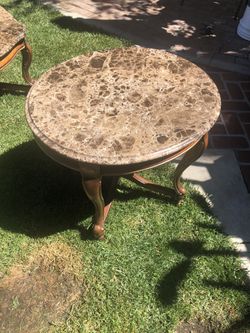 3 brown marble tables