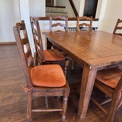 Rustic dining table with 8 wooden chairs with pads