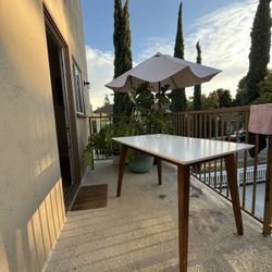 Kitchen Table: White top, wooden legs