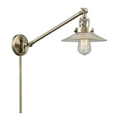 TWO 1 - Light Dimmable Plug-in Swing Arm lamps in antique brass and clear glass shades. 25” H x 8.5” W x 21” D. MSRP $696. Our price $170 + sales tax