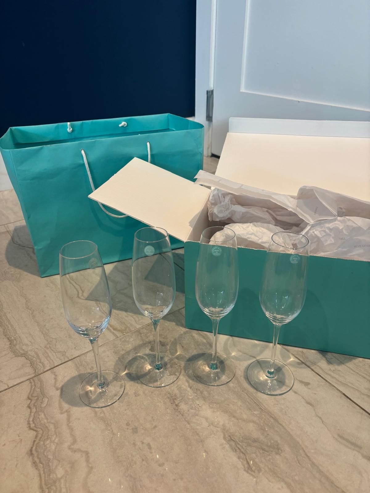 Perfect for showers and weddings! Tiffany and Company, champagne flutes- four glasses .. We’re selling FOUR for $200. Comes with original box and ba