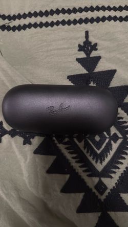 Ray-Ban Meta Wayfarer-style smart glasses with the charging case