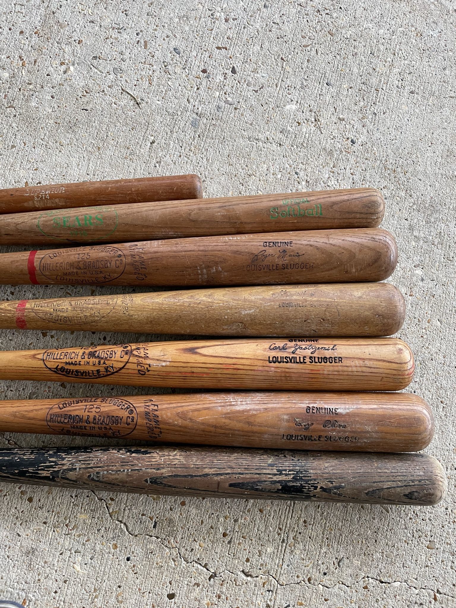 Vintage Wooden Baseball Bats including Louisville Sluggers. Vintage metal baseball bats and gloves from 1970's. Balls.