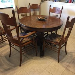 Antique table ( late 1890’s) and 6 chairs includes captains chair and two leaves. Recently refinished and new pads, seats, material and table leg rol