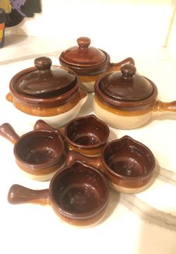 10 piece ceramic pots with pouring cups and lids.