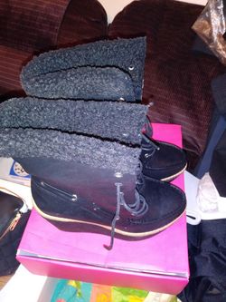 Thigh high black boots with fur on the inside.